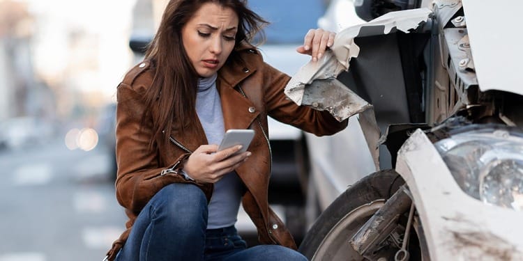 A woman at the crash site, calling your car accident lawyer is key