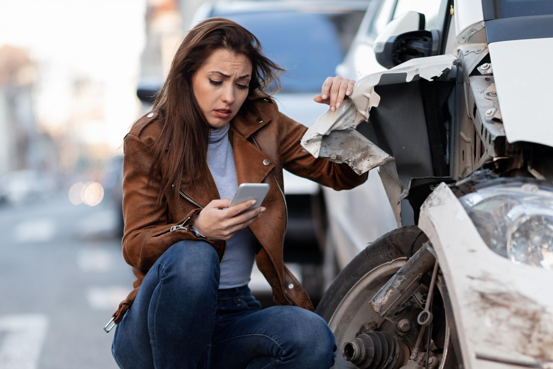 A woman at the crash site, calling your car accident lawyer is key