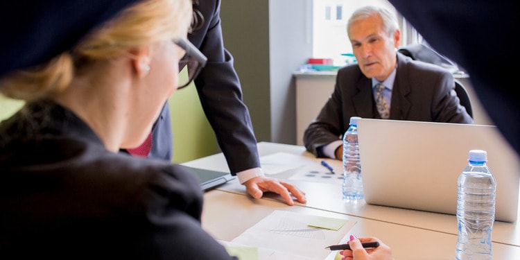 3 Fraud Offences Lawyers in the office going through a case review.