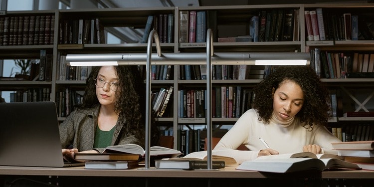 Two women, using their learning skills to leap forward in their studies.