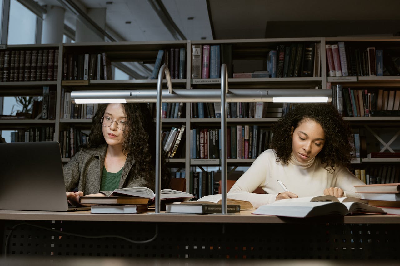 Two women, using their learning skills to leap forward in their studies.