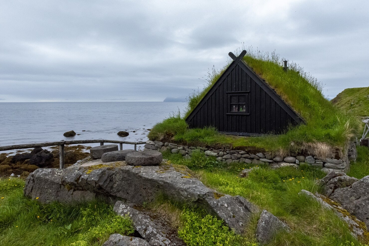 Scandinavia eco-friendly travel: Nature is a treated like a relative fishing village with grass-roofed homes and fish drying racks